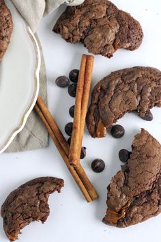 chocolate cookies and cinnamon sticks on a plate