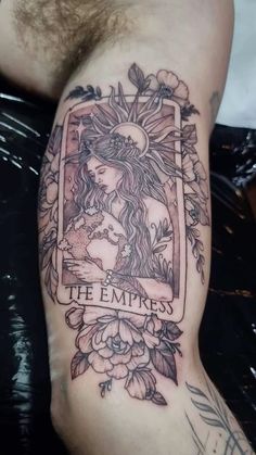 a tattoo with an image of a woman and flowers on her arm that says the empties