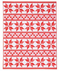 a red and white quilt with an arrow pattern