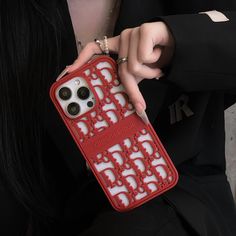 a woman is holding an iphone case in her hand