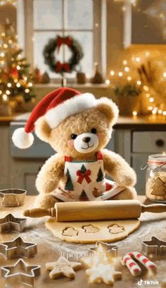 a brown teddy bear sitting at a table with christmas decorations and cookies in front of it