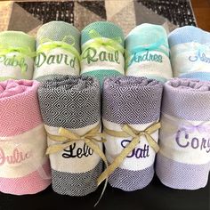 several rolls of personalized hand towels on a table