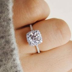 a woman's hand with a diamond ring on top of her finger and the words, how to choose an engagement ring