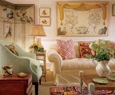 a living room filled with furniture and pictures on the wall