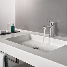 a bathroom sink with a faucet and soap dispenser