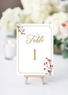 a table number card with red berries on it