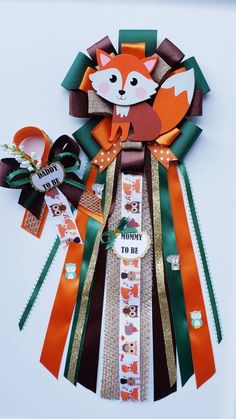 an orange and green ribbon with a fox on it