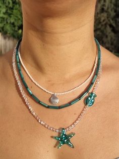 This multi-strand layering necklace set features a 925 sterling silver design with three layers of coral beads, hematite, and a starfish Murano pendant.  ⚖WEIGHT The set of necklaces weighs approximately 33 g (1.1 oz). ✨MATERIALS The gemstones are Mother of Pearls, Hematites, and Corals. The other beads are rainbow bohemian crystals. The lobster claw clasp, extension chain, and finish are silver-plated. The size of the cylinder mother of pearls is 4x13 mm. The size of the corals is 2x2 mm. The sizes of the hematites are 4x1 mm. The sizes of the bohemian crystals are 2x4 mm. The size of the murano pendant (starfish) is 27x27 mm. The size of the murano pendant (fish) is 5x10 mm. The size of the 925 sterling silver pendant (seashell) is 5x6 mm. 🙌SATISFACTION ♥ Your satisfaction is our top pr White Sterling Silver Double Strand Jewelry, White Double Strand Layered Jewelry, White Layered Double Strand Jewelry, Adjustable Layered Silver Jewelry, Sterling Silver Double Strand Beaded Jewelry, Handmade Multi-strand Sterling Silver Necklace, Multi-strand Sterling Silver Jewelry For Layering, Sterling Silver Multi-strand Jewelry For Layering, Multi-strand Beaded Sterling Silver Necklace