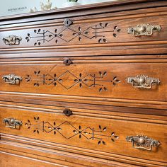 an old wooden dresser with ornate carvings and knobs on the drawers is shown in this image