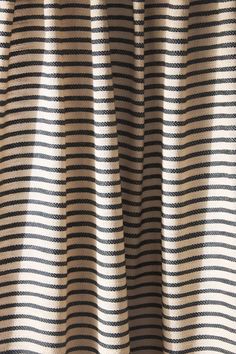 a close up view of a black and white striped curtain