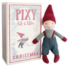 a stuffed toy is next to a boxed christmas card and it's in the shape of a doll