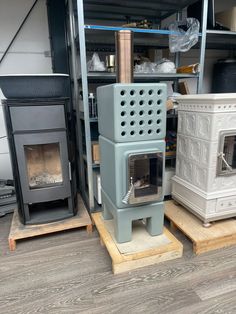 several different types of wood burning stoves on pallets next to eachother