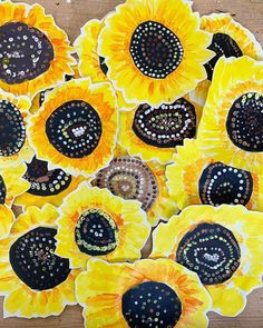 sunflowers are painted with dots on black and yellow paper