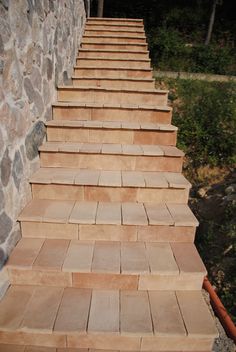 the steps are made of stone and have brown tiles on them