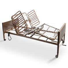 a hospital bed with metal rails and wooden slats on the bottom, against a white background