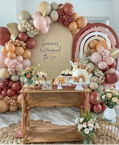 the dessert table is set up with balloons and flowers