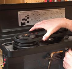 a man is touching the control panel on a machine that has been turned on and replaced