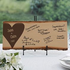 a wooden sign with writing on it sitting on a table