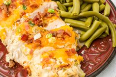 a close up of a plate of food with beans and green beans on the side