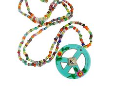 A unique and artful turquoise peace sign pendant featuring a hand-painted floral design dangles whimsically from a long, beaded necklace to add colorful Boho style to any outfit! And from inside the painted flowers, tiny crystal rhinestones add a touch of sparkle! Super cute piece of wearable art for you and maybe a little gift for a friend...buy 2 at a discount! Beaded Seed Bead Necklace, 28", Ceramic Peace Sign Pendant, 1 1/4" round  MANY ARTFUL ITEMS ARE AVAILABLE IN MY SHOP! VISIT MY SHOP GODDESS ARTS COLLECTION www.etsy.com/shop/goddessartcollection                          SPECIAL SHIPPING RATES!!                         FREE US SHIPPING(certain items excluded)                         REDUCED INTERNATIONAL & CANADA  **CUSTOM ORDERS WELCOMED** Put my brush and skill to work for you! s Symbolic Multicolor Festival Jewelry, Hippie Style Green Beaded Necklace For Festivals, Symbolic Multicolor Beaded Jewelry, Spring Bohemian Jewelry With Colorful Beads, Bohemian Spring Jewelry With Colorful Beads, Hippie Green Jewelry With Colorful Beads, Hippie Green Round Bead Necklaces, Hippie Beach Jewelry For Spring, Hippie Style Beach Jewelry For Spring