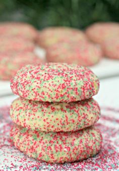 soft christmas sprinkle cookies stacked on top of each other with text overlay