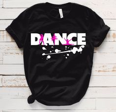 a black t - shirt with the word dance painted in white and pink on it