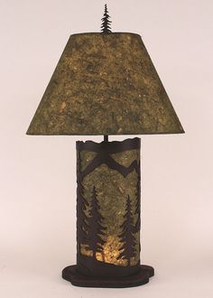 a lamp that is sitting on top of a wooden base with a brown shade over it