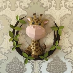 a giraffe sitting on top of a wall with leaves around it's neck