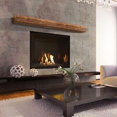 a living room with a couch, coffee table and fire place in the fireplace area