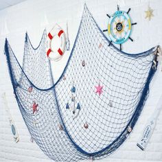 there is a blue net on the wall with various items hanging from it's sides