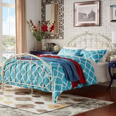 a bedroom with white furniture and blue bedding