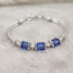 This unique, one-of-a-kind September sapphire bracelet makes the perfect gift for moms, grandmas, bridesmaids, or any special woman in your life. Gift them on birthday, anniversary, family reunion, mothers day, wedding day, anniversary and Christmas and more! ABOUT THIS ITEM: * 6mm austrian crystals * pewter bead caps * silver plated tube beads * pewter toggle * sapphire crystals are used in the photos above SHIPPING: * Processing time is 1-3 business days. RUSH ORDERS can be purchased from the