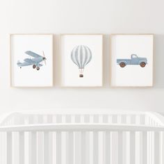 three framed pictures hang on the wall above a crib