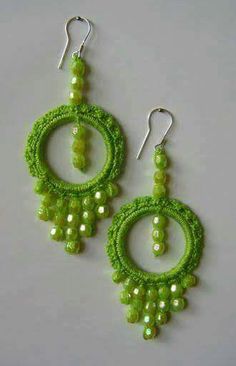 green beaded earrings with pearls and beads hanging from the end of each earring