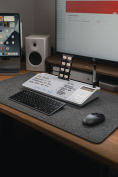 a desk with a keyboard, mouse and monitor on it next to a laptop computer