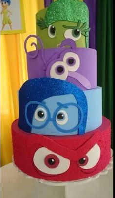 the cake is decorated with different colors and eyes