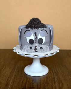 a cake decorated to look like an old tv set with eyes and nose on top