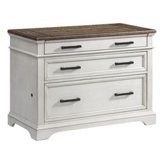 a white dresser with wooden top and drawers