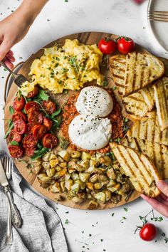 a plate filled with different types of food on top of a white table next to utensils