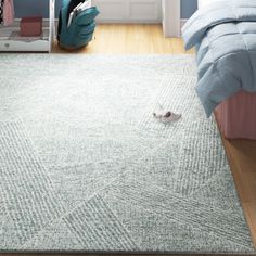 a bedroom with blue walls and white carpeting on the floor, including a bed