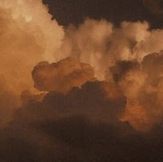 an airplane is flying in the sky with clouds