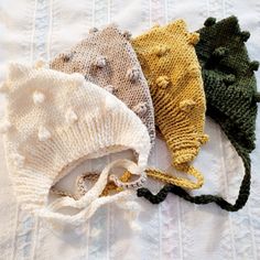 three knitted hats laying on top of each other