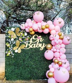 a baby shower backdrop with balloons and flowers