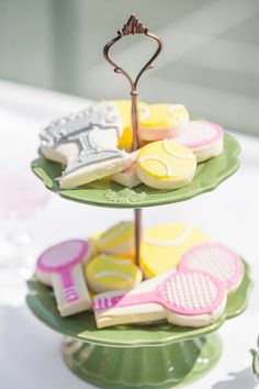 three tiered trays with cookies and candies on top of each other in different colors