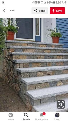 stone steps leading up to a blue house