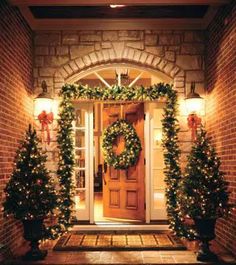 the front door is decorated for christmas with wreaths and lights