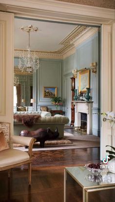 a living room filled with furniture and a fire place in the middle of a room