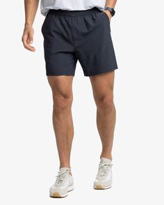 The front view of the Southern Tide Rip Channel 6 Inch Performance Short by Southern Tide - Caviar Black Functional Breathable Activewear With 5-inch Inseam, Athleisure Athletic Shorts With Built-in Shorts For Outdoor, Casual Training Shorts With 5-inch Inseam, Functional Running Shorts With 5-inch Inseam, Sporty Workout Athletic Shorts With 5-inch Inseam, Outdoor Sportswear With Built-in Shorts, Sporty Gym Athletic Shorts With 5-inch Inseam, Moisture-wicking Recycled Polyester Running Shorts, Stretch Athletic Shorts In Recycled Polyester For Running