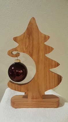 a wooden ornament with a christmas tree on it