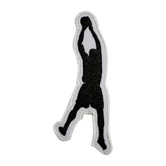 a black and white basketball player with the ball in his hand embroidered on a white background